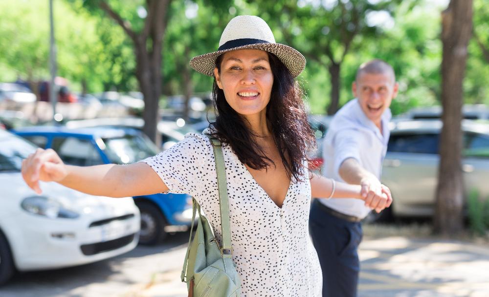 woman with hat reaching outward | bruxism treatment avondale