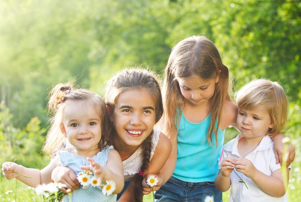 four children playing outside | dentist auckland