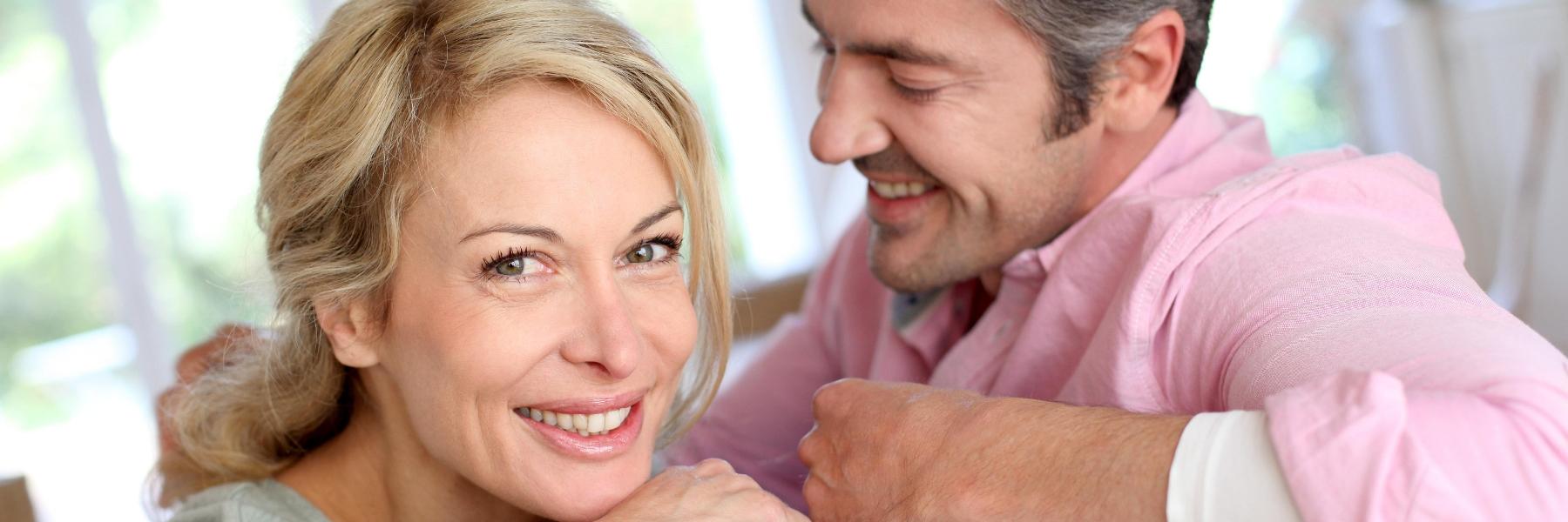 Couple sitting on couch | Cosemtic Dentistry in Avondale