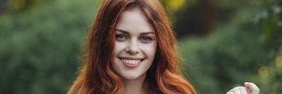 A smiling lady after getting dental crowns in Avondale, Auckland