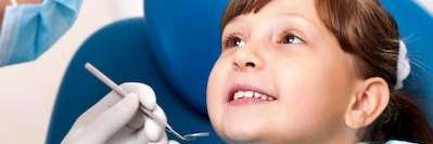 young child sitting in dentist exam chair | avondale dental