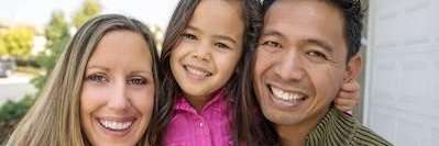 family of three hugging | avondale dentist