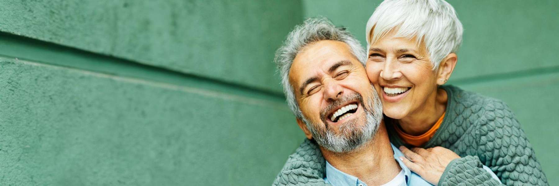A elderly couple smiling after a denture treatment in Avondale, Auckland