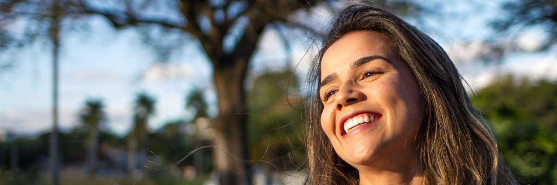 A woman smiling after taking Preventive dentistry option in Avondale, Auckland